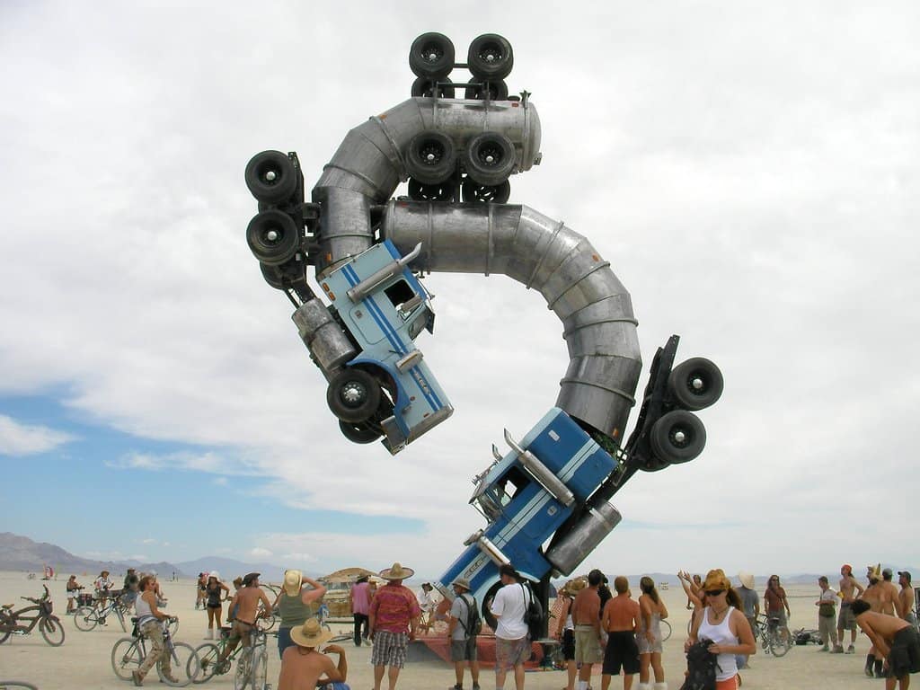 Trucks stacked in a giant sculpture at Burning Man